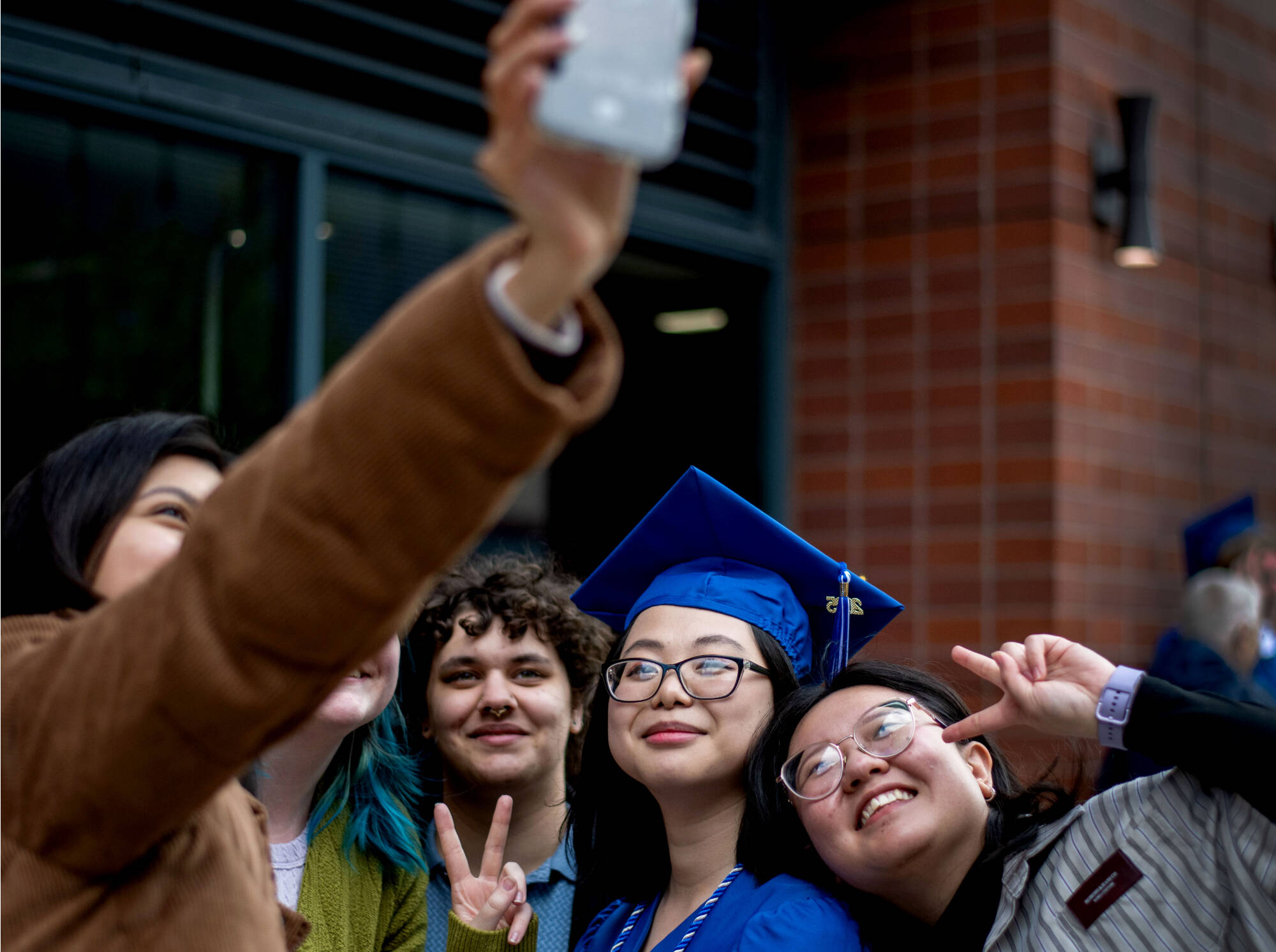 a GVSU family celebrating commencement with their daughter